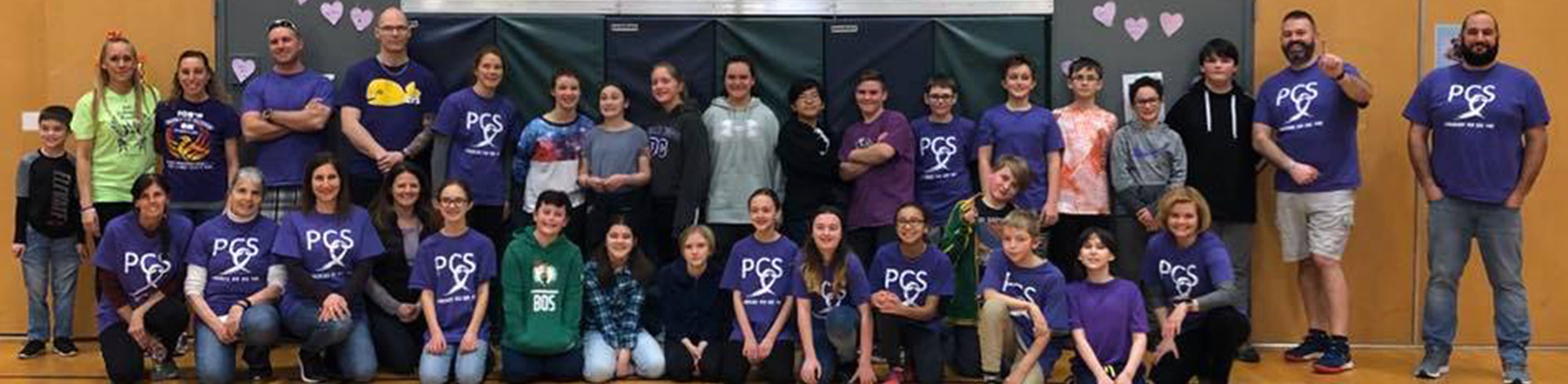 Group of students in the gym posing for a picture